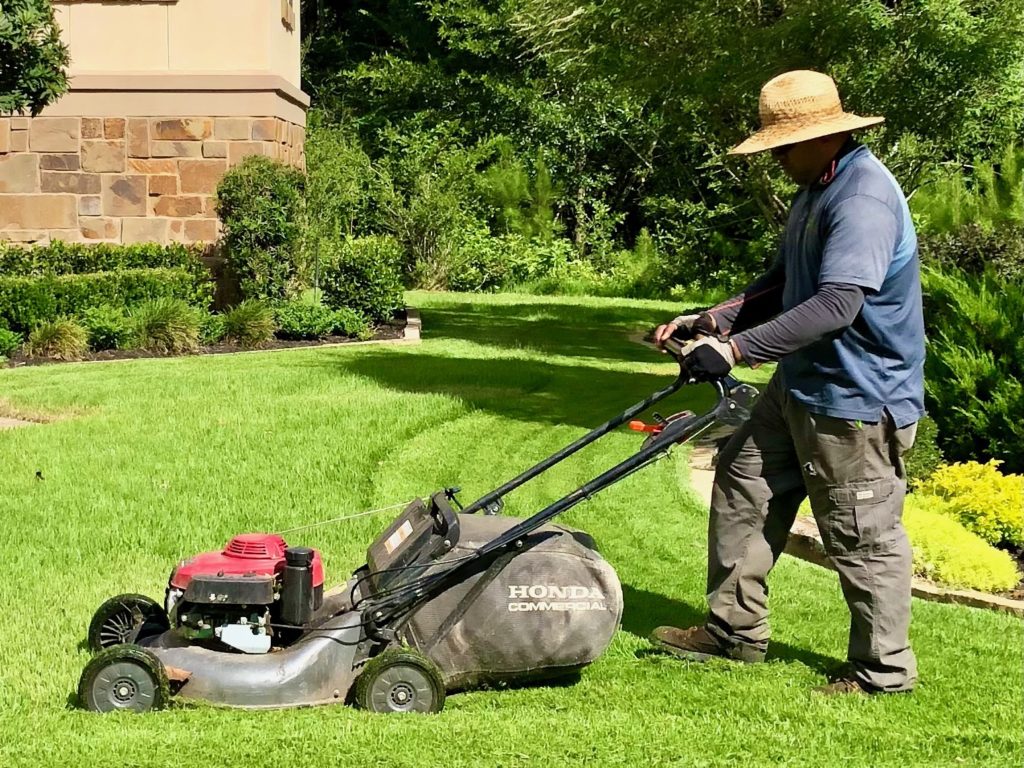 photo of man mowing the lawn