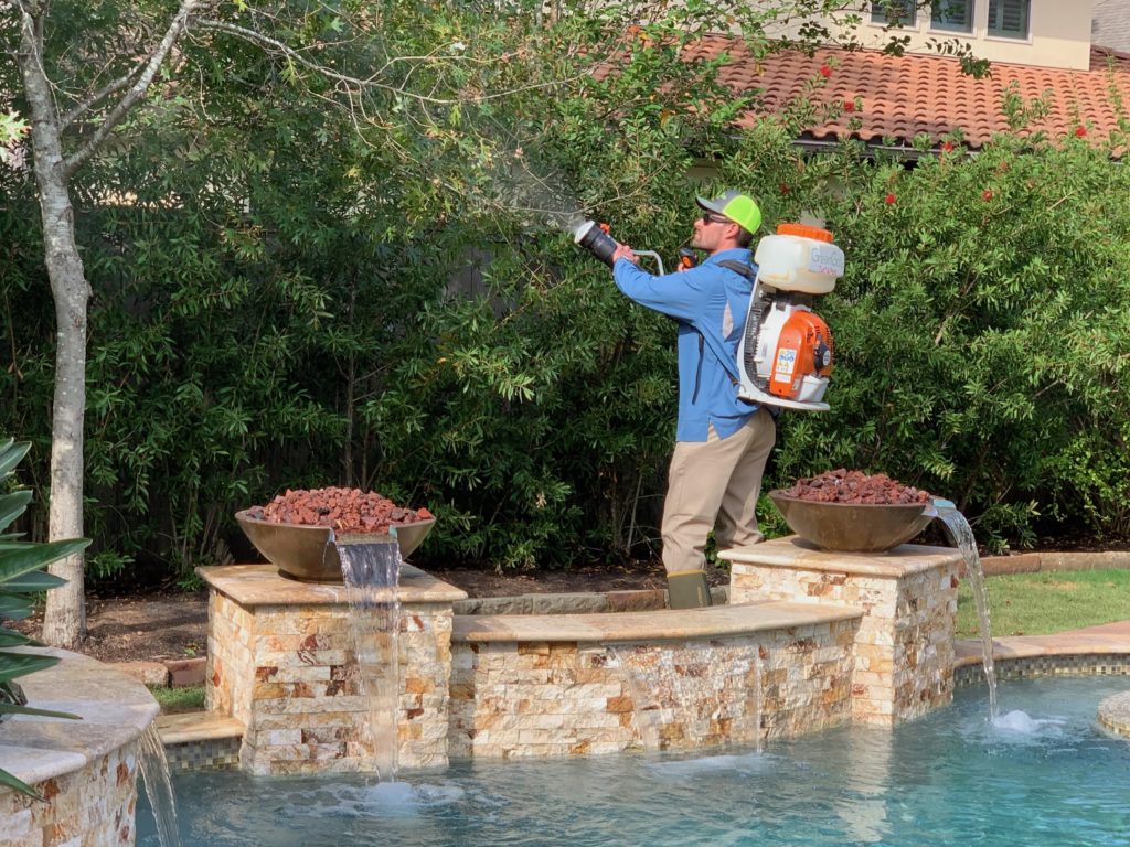 GreenGate pest control technician applying mosquito treatment for yard