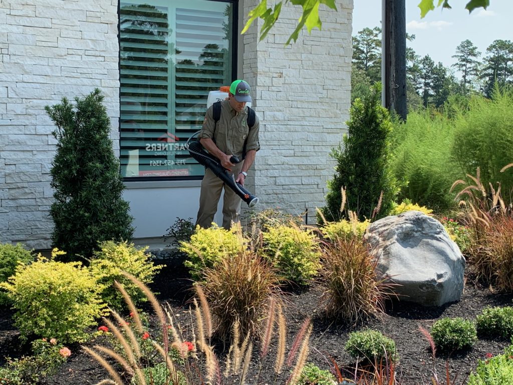 GreenGate Turf & Pest technician completing mosquito control service at a Houston, TX office.