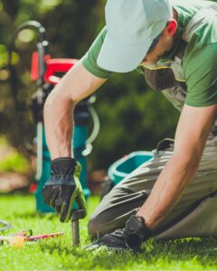 Irrigation technician performing spring sprinkler maintenance