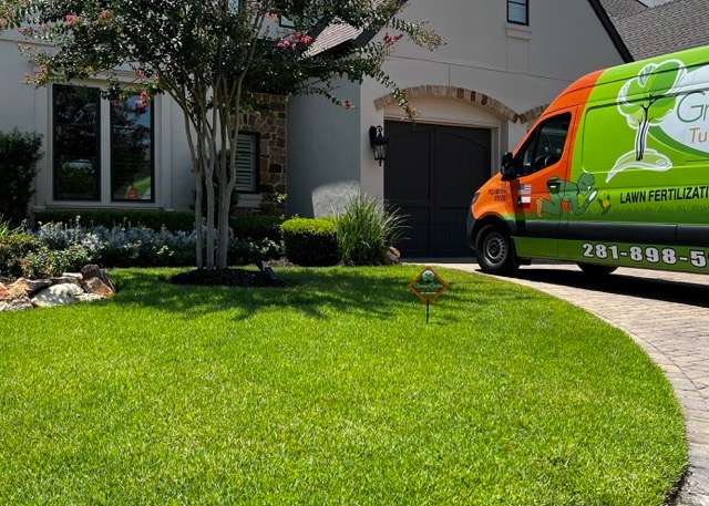 A Green Gate Service Van Outside the House for Lawn Care Services in Katy, TX