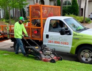 A Green Gate Technician Performing Lawn Mowing Service in Cypress, TX