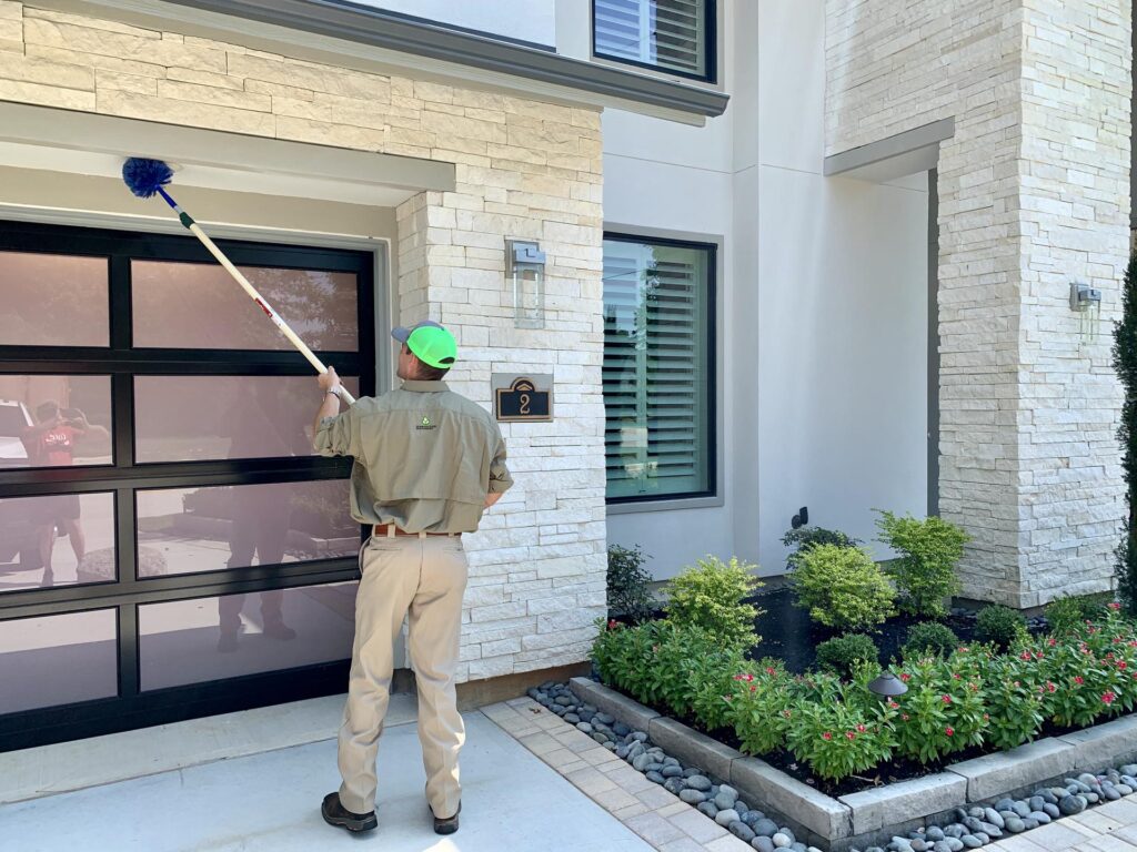 GreenGate technician de-webbing home from webs and spiders in houston