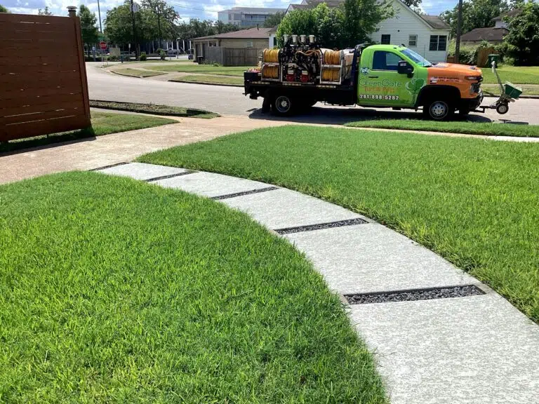 GreenGate Turf & Pest Truck parked near a green lawn - Treated for weeds and completed lawn aeration services