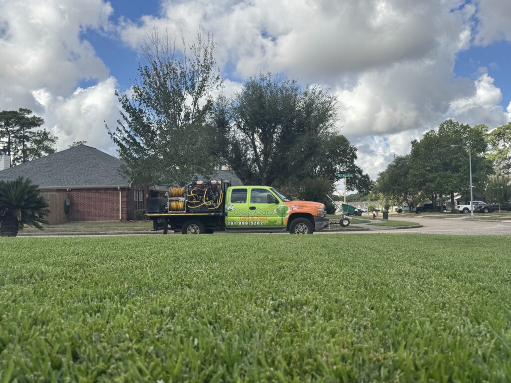 GreenGate Truck next to a green lawn after a completed lawn bundle service with lawn pest control, weed control, fungus control, and lawn aeration services