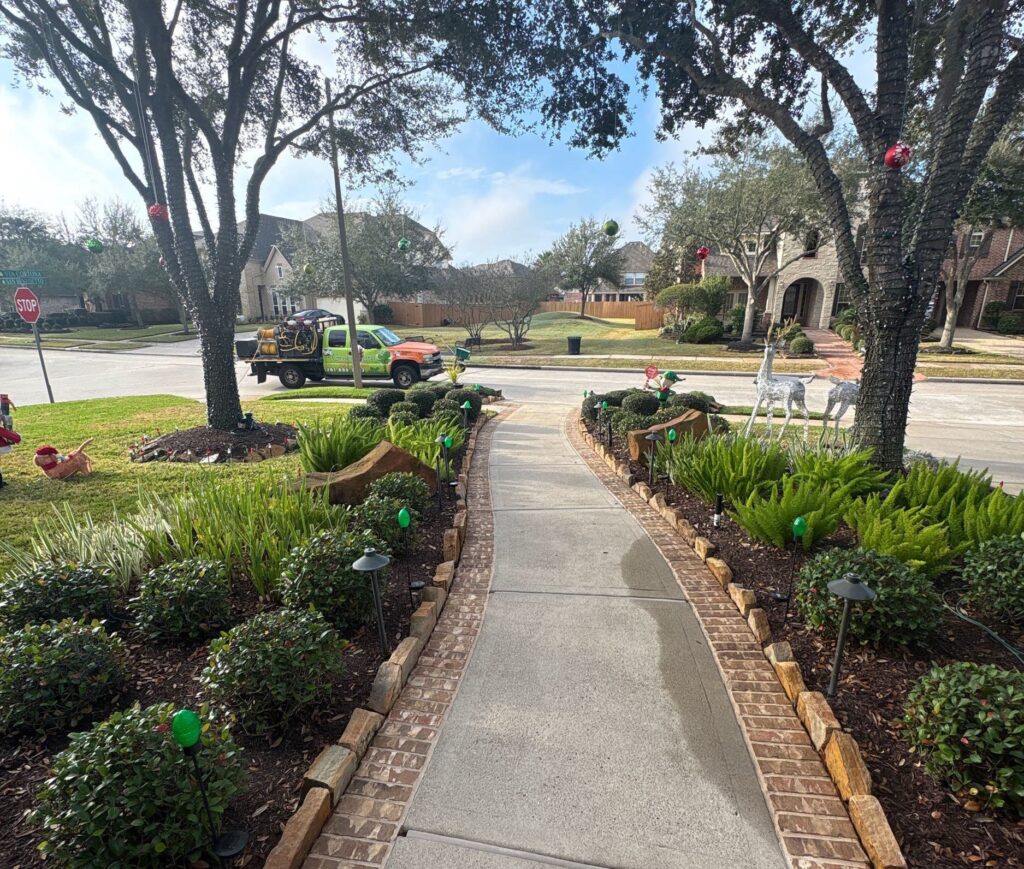 GreenGate vehicle parked outside of a lawn that receives lawn fertilizer service, lawn pest control, lawn fungus control, lawn aeration service, and sod webworm treatments