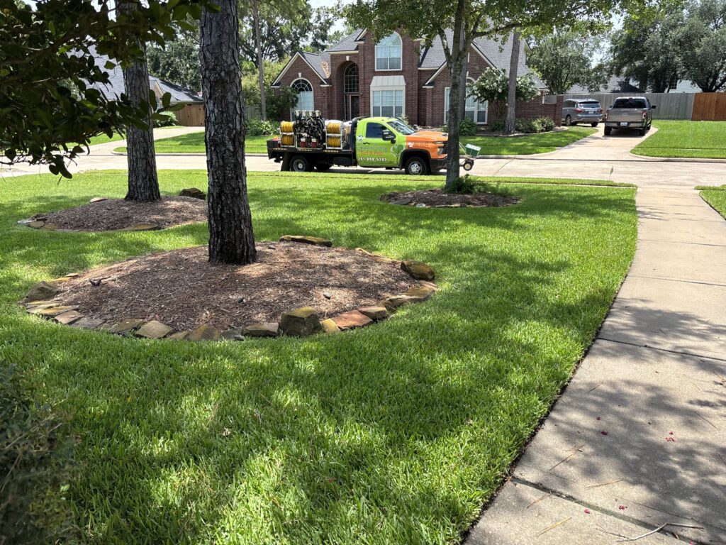 GreenGate truck parked in front of a lush, green lawn after completing lawn insecticide services, that includes chinch bug treatment, in Missouri City