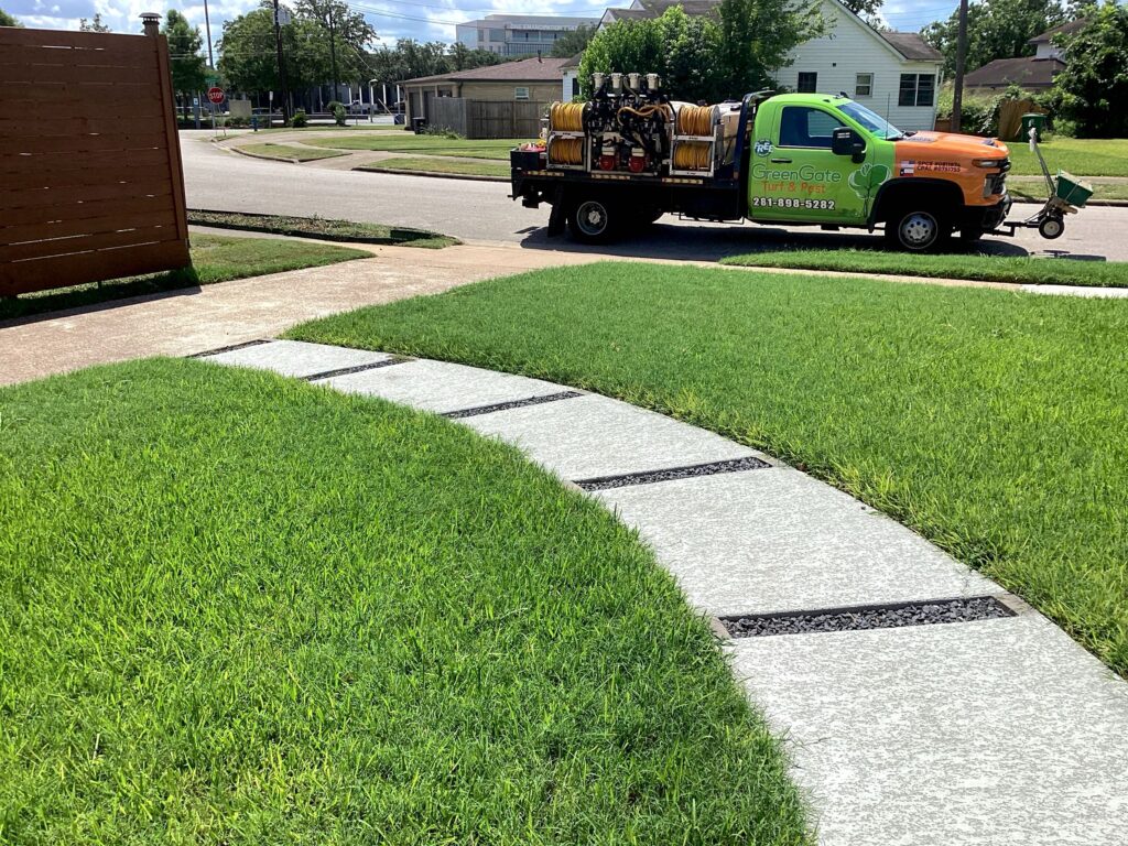 GreenGate Truck parked in front of a green, lush lawn that just received a lawn pest control treatment