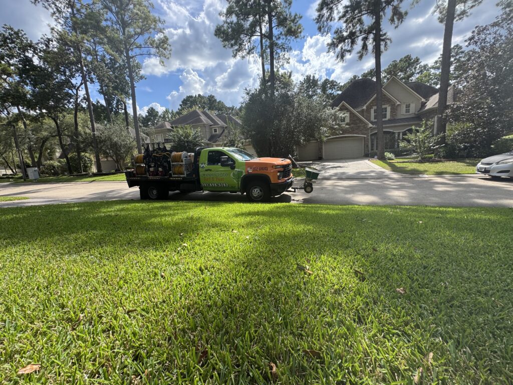 Greengate truck parked near a green lawn with no weeds after a lawn insecticide treatment