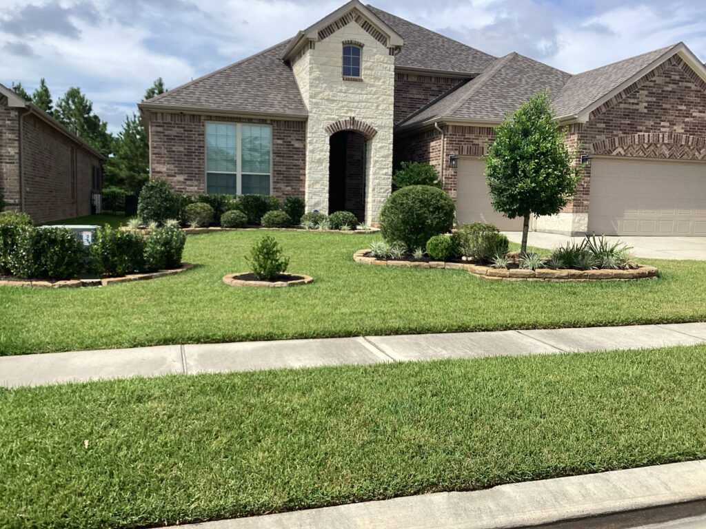 View of the front of a home with 3 flower beds in the front yard after a perimeter pest control service