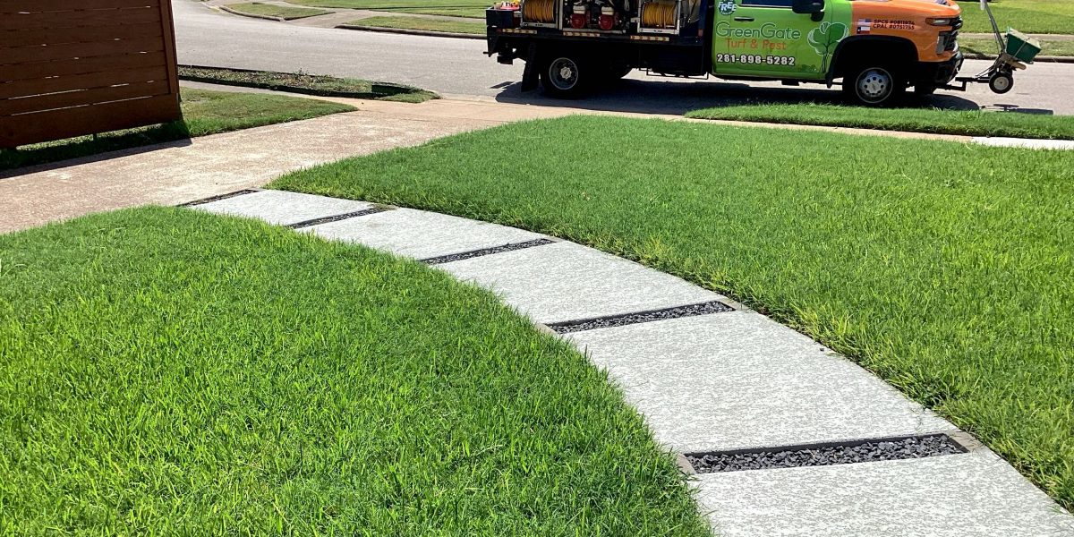 GreenGate Turf & Pest Truck parked near a green lawn - Treated for weeds and completed lawn aeration services