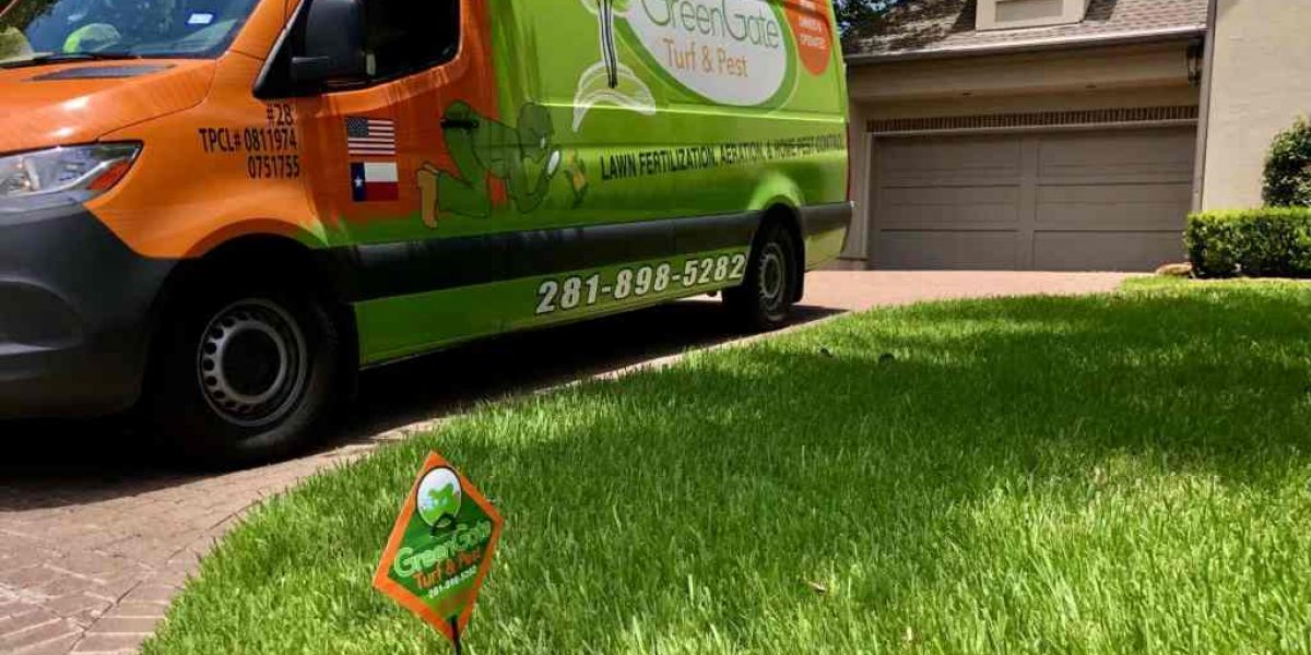 A Green Gate Truck Outside the House Showcasing Lawn Fertilization in Houston, TX